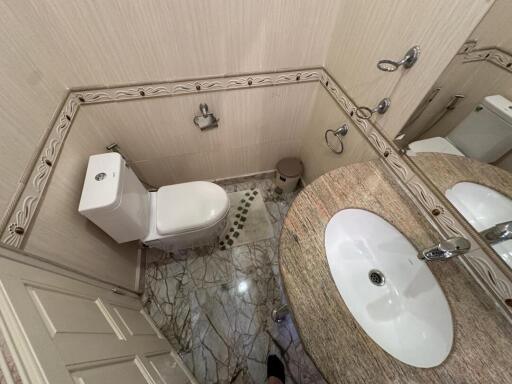 Spacious modern bathroom with marble flooring and elegant fixtures