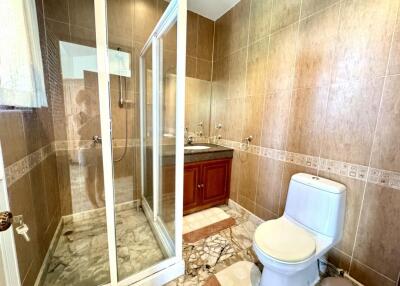 Modern bathroom with glass shower and marble tiles