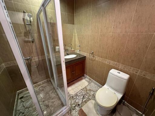 Modern bathroom with shower cabin and marble tiles