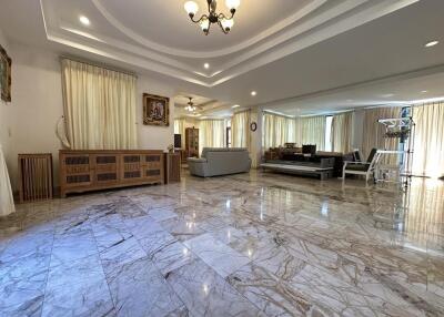 Spacious living room with polished marble flooring and elegant decor