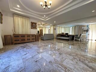 Spacious living room with polished marble flooring and elegant decor