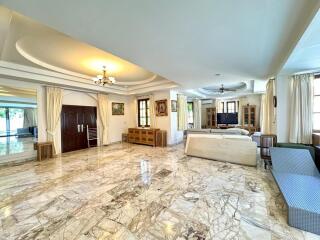 Spacious living room with marble flooring and ample natural light