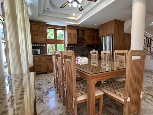 Spacious kitchen with wooden cabinets and dining area