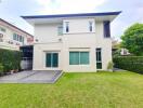 Modern two-story house with a well-maintained lawn and driveway