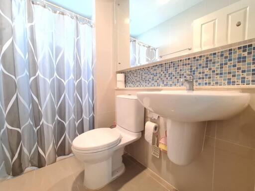 Clean and modern bathroom with blue tile accents