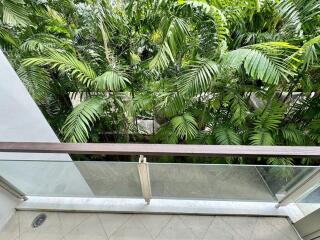 View from a balcony overlooking lush greenery