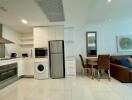 Modern kitchen with stainless steel appliances and adjacent dining area