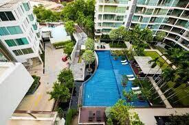 Aerial view of a residential building complex with swimming pool and garden