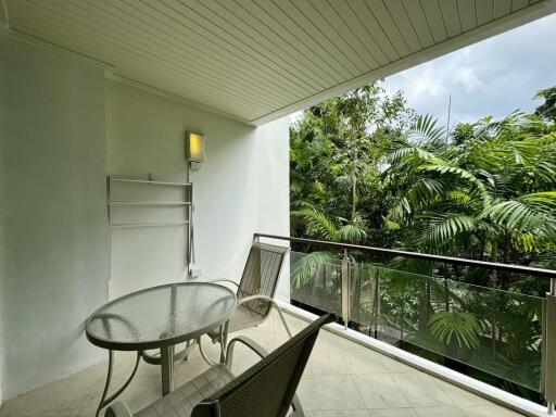 Spacious balcony with a view of lush greenery