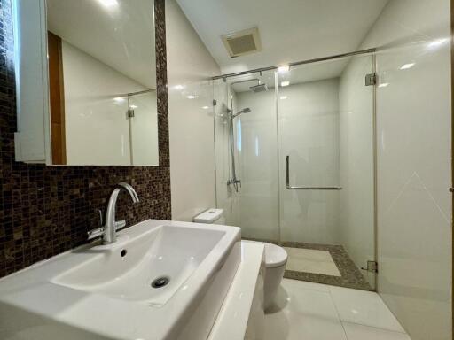 Modern bathroom with glass shower and white fixtures