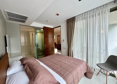 Comfortable bedroom with large bed, en-suite bathroom and floor-to-ceiling windows