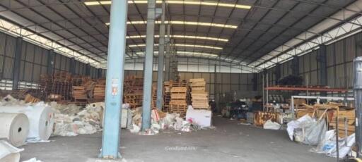 Industrial warehouse interior with storage pallets and materials