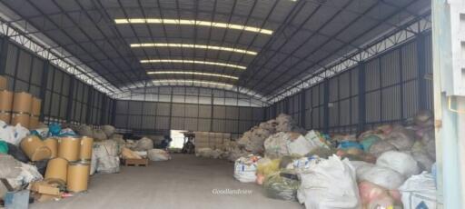 Spacious industrial warehouse interior with storage goods