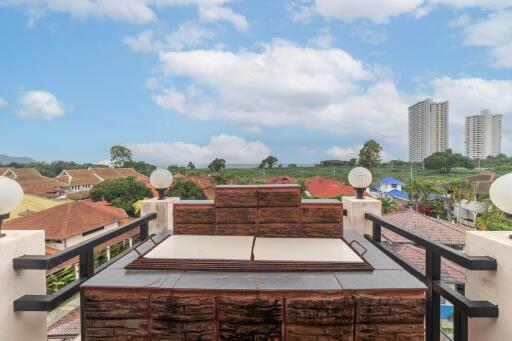 Spacious balcony with brick parapet walls and panoramic view of the city skyline