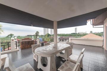 Spacious balcony with ocean view and outdoor seating