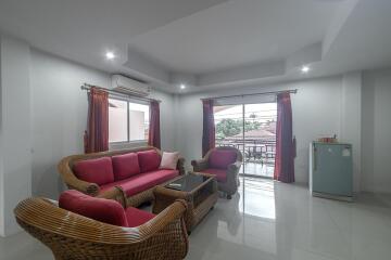 Spacious and Bright Living Room with Modern Furniture and Balcony Access