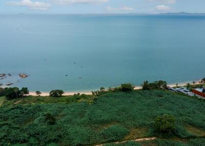 Aerial view of coastal property with expansive sea views and lush greenery
