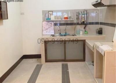 Compact kitchen with appliances and tiled backsplash