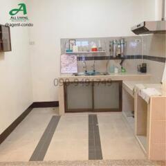 Compact kitchen with appliances and tiled backsplash