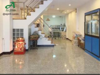 Spacious lobby area with marble flooring and staircase