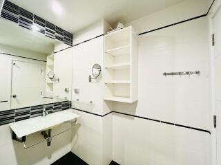 White modern bathroom with wall-mounted sink and open shelving