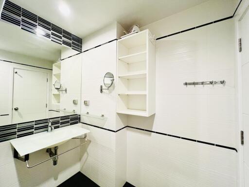 White modern bathroom with wall-mounted sink and open shelving