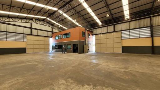 Spacious warehouse interior with central office block