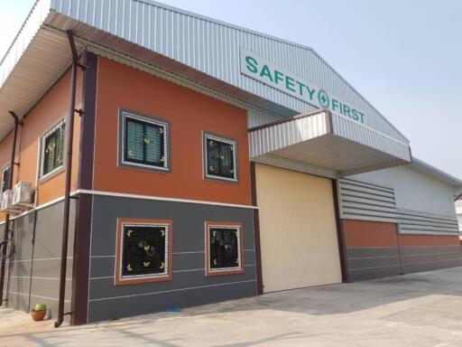 Orange and gray industrial building with safety signage