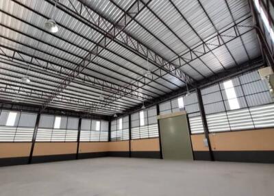 Spacious empty industrial warehouse interior with high ceiling