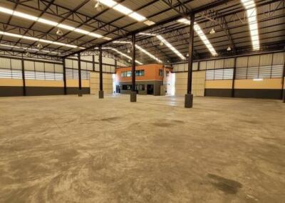 Spacious empty interior of a large industrial building with high ceiling