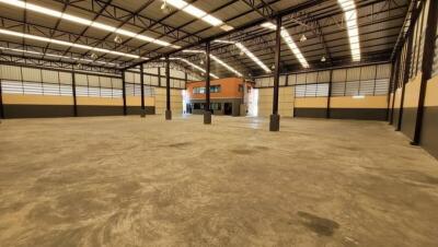 Spacious empty interior of a large industrial building with high ceiling
