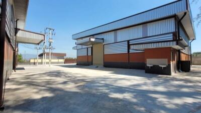 Spacious industrial warehouse exterior with loading docks