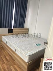 Bright bedroom with large window and double bed