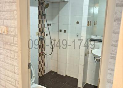 Compact modern bathroom with white tiles and shower