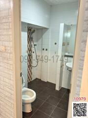 Compact modern bathroom with white tiles and shower