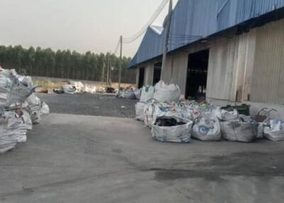 Industrial warehouse exterior with large bags of materials