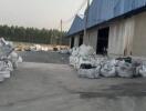 Industrial warehouse exterior with large bags of materials