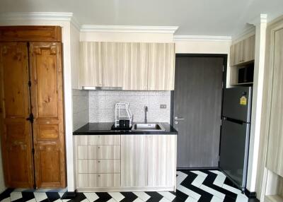 Modern kitchen with black and white checkered floor and wooden details