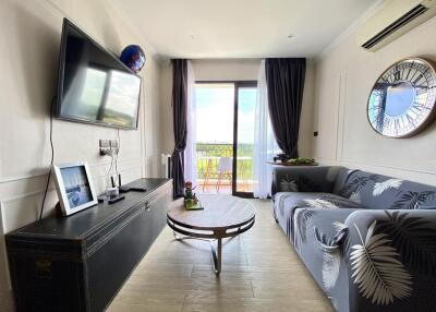 Spacious living room with natural light and balcony access