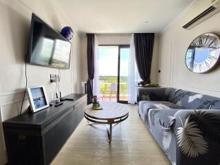 Spacious living room with natural light and balcony access