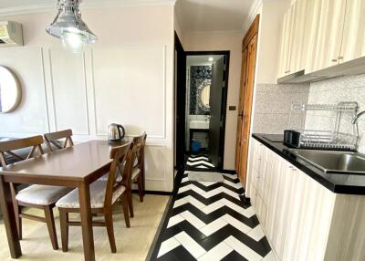 Modern kitchen with chevron floor pattern and dining area