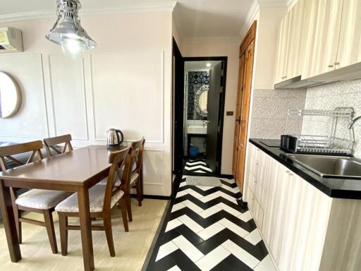 Modern kitchen with chevron floor pattern and dining area