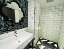 Modern bathroom with white subway tiles and black and white patterned walls