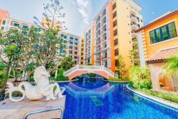 Luxurious apartment building with a swimming pool and lush landscaping