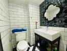 Spacious bathroom with white-and-black tile design, modern fixtures, and large mirror