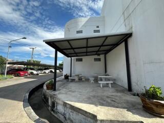 Covered outdoor seating area adjacent to building