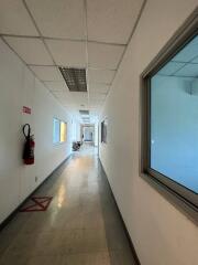 Long narrow hallway with windows in a commercial building