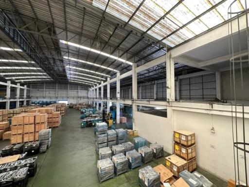 Spacious warehouse interior with high ceiling and storage