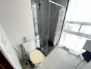 Compact modern bathroom with shower cubicle and tile finishing