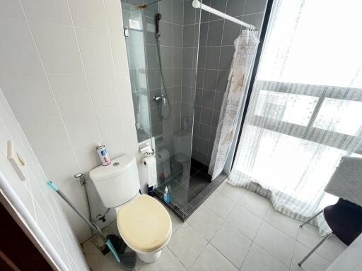Compact modern bathroom with shower cubicle and tile finishing